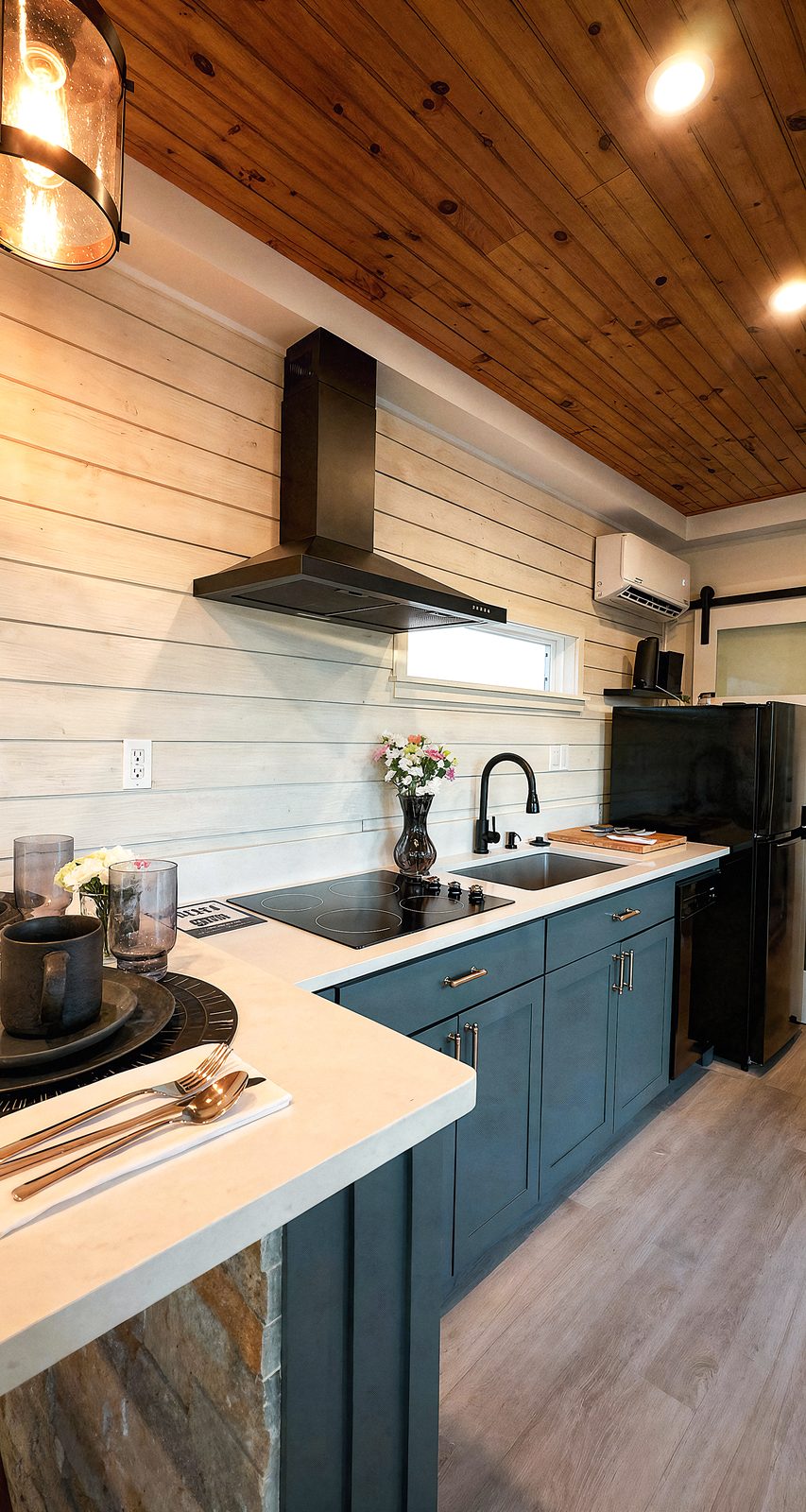 Kitchen - range hood, countertop, blue cabinets